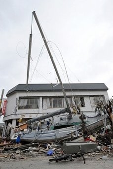 A washed up boat lays in front a house in the devastated city of Ofunato following the devasting earthquake and ensuing tsunami on March 11 A washed up boat lays in front a house in the devastated city of Ofunato following the devasting earthquake and ensuing tsunami on March 11