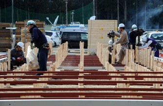 Construction workers start building the temporary housing for survivors on the grounds of a junior high school in the city of Rikuzentakata in Iwate prefecture on March 19, 2011 Construction workers start building the temporary housing for survivors on the grounds of a junior high school in the city of Rikuzentakata in Iwate prefecture on March 19, 2011