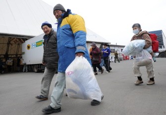 People collect blankets and clothing from a distribution centre in the city of Kamaishi in Iwate prefecture on March 20, 2011. AFP People collect blankets and clothing from a distribution centre in the city of Kamaishi in Iwate prefecture on March 20, 2011. AFP