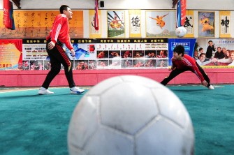 AFP file - This April 2, 2010 photo shows martial arts students at a Kung fu school in the northern suburbs of Beijing practicing their technique with a soccer ball AFP file - This April 2, 2010 photo shows martial arts students at a Kung fu school in the northern suburbs of Beijing practicing their technique with a soccer ball