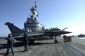 French Marines prepare a Rafale jet fighter on the deck of the French aircraft carrier Charles De Gaulle on March 25, 2011. AFP French Marines prepare a Rafale jet fighter on the deck of the French aircraft carrier Charles De Gaulle on March 25, 2011. AFP