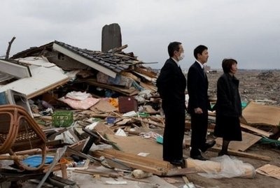AFP - A family stands amidst the rubble of the Yuriage district of Natori town, in Miyagi prefecture after attending a cremation. AFP - A family stands amidst the rubble of the Yuriage district of Natori town, in Miyagi prefecture after attending a cremation.