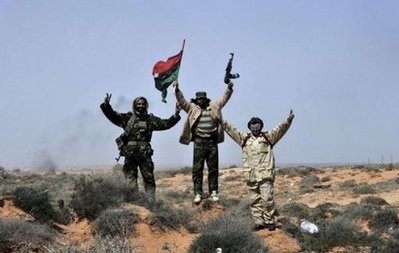 Libyan rebels celebrate as they advance from the village of Harawa towards Moamer Kadhafi's hometown of Sirte Libyan rebels celebrate as they advance from the village of Harawa towards Moamer Kadhafi's hometown of Sirte
