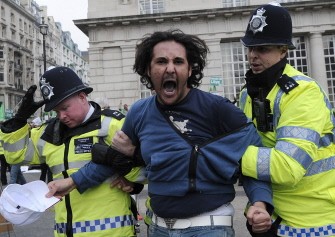 A protestor (C) is led away by police while taking part in a pro-Kadhafi demonstration in London, on March 29, 2011. AFP A protestor (C) is led away by police while taking part in a pro-Kadhafi demonstration in London, on March 29, 2011. AFP