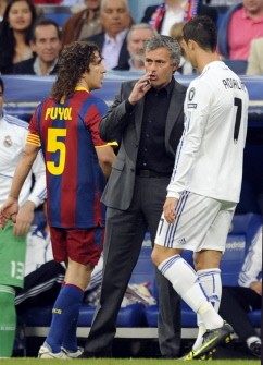 AFP - Real Madrid's Portuguese coach Jose Mourinho (C) speaks with Real Madrid's Portuguese forward Cristiano Ronaldo (R) next to Barcelona's captain Carles Puyol (L) during the Champions League semi-final first leg between Real Madrid and Barcelona on April 27, 2011 . Barcelona won 0-2. AFP - Real Madrid's Portuguese coach Jose Mourinho (C) speaks with Real Madrid's Portuguese forward Cristiano Ronaldo (R) next to Barcelona's captain Carles Puyol (L) during the Champions League semi-final first leg between Real Madrid and Barcelona on April 27, 2011 . Barcelona won 0-2.