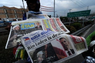 AFP - A newspaper hawker sells newspapers with images and news featuring Osama Bin Laden's death at the Coastall road in Manila, the Philippines on May 3, 2011. AFP - A newspaper hawker sells newspapers with images and news featuring Osama Bin Laden's death at the Coastall road in Manila, the Philippines on May 3, 2011.