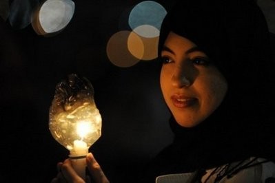 AFP - A Libyan woman holds a candle during a candlelight vigil in Benghazi to show solidarity with the people of Misrata and Tripoli. AFP - A Libyan woman holds a candle during a candlelight vigil in Benghazi to show solidarity with the people of Misrata and Tripoli.