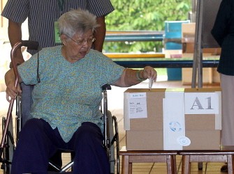 AFP - An elderly woman places her vote in the ballot at the polling centre in Singapore on May 7, 2011. AFP - An elderly woman places her vote in the ballot at the polling centre in Singapore on May 7, 2011.