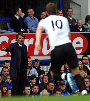Manchester City's Roberto Mancini (L) directs his team during the game