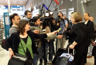 AFP - A passenger arriving on an Air France flight from New York answers journalists questions at Charles De Gaulle Airport in Roissy, suburb Paris, on May 15, 2011. IMF's Strauss-Kahn was arrested minutes before he was to leave for France AFP - A passenger arriving on an Air France flight from New York answers journalists questions at Charles De Gaulle Airport in Roissy, suburb Paris, on May 15, 2011. IMF's Strauss-Kahn was arrested minutes before he was to leave for France