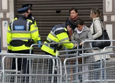 AFP - Irish police search handbags near the Garden of Remembrance in Dublin ahead of the visit of Queen Elizabeth. AFP - Irish police search handbags near the Garden of Remembrance in Dublin ahead of the visit of Queen Elizabeth.