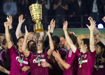 AFP - Schalke's players throw the cup AFP - Schalke's players throw the cup