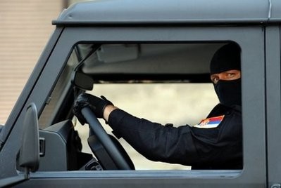 A Serbian police officer secures a convoy allegedly carrying Bosnian Serb ex-army chief Ratko Mladic from Belgrade to the city airport on May 31, 2011. A Serbian police officer secures a convoy allegedly carrying Bosnian Serb ex-army chief Ratko Mladic from Belgrade to the city airport on May 31, 2011.