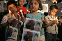 Syrian children carry pictures of 13-year-old Hamza al-Khatib and hold candles during a protest Syrian children carry pictures of 13-year-old Hamza al-Khatib and hold candles during a protest