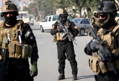 Iraqi anti-terror police guard a checkpoint in Baghdad Iraqi anti-terror police guard a checkpoint in Baghdad