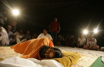 Indian yoga guru Baba Ramdev sleeps on a stage as he continues his protest hunger strike at his ashram, or spiritual headquarters, in Haridwar, India, late Sunday, June 5, 2011 Indian yoga guru Baba Ramdev sleeps on a stage as he continues his protest hunger strike at his ashram, or spiritual headquarters, in Haridwar, India, late Sunday, June 5, 2011