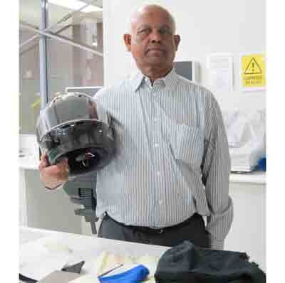 Dr Sinnappoo Kanesalingam with a motorcycle helmet and the innovative textile materials . Dr Sinnappoo Kanesalingam with a motorcycle helmet and the innovative textile materials .