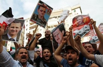 AFP - Lebanese protesters and Syrians living in Lebanon hold pictures of Syrian President Bashar al-Assad during a rally in a Shiite suburb of Beirut to show their support for Assad on June 4, 2011. AFP - Lebanese protesters and Syrians living in Lebanon hold pictures of Syrian President Bashar al-Assad during a rally in a Shiite suburb of Beirut to show their support for Assad on June 4, 2011.