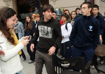 AFP - Lionel Messi is surrounded by high school students as he leaves a restaurant after a football fanatic tried to punch him on the face while he was signing autographs in his native Rosario, Argentina, on June 2, 2011. AFP - Lionel Messi is surrounded by high school students as he leaves a restaurant after a football fanatic tried to punch him on the face while he was signing autographs in his native Rosario, Argentina, on June 2, 2011.