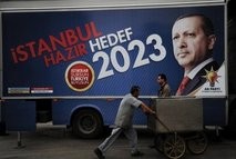 AFP – A worker pushes a cart past a campaign poster for Turkish Prime Minister Recep Tayyip Erdogan in Istanbul AFP – A worker pushes a cart past a campaign poster for Turkish Prime Minister Recep Tayyip Erdogan in Istanbul