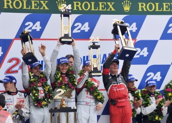 (L-R) Drivers of the Audi R18 n°2, French Benoit Treluyer, German Andre Lotterer and Swiss Marcel Fassler (partially hidden), celebrate on the podium with Audi's team manager Wolfgang Ulrich (R), after wining the 79th edition of Le Mans 24 hours endurance race, on June 12, 2011 (L-R) Drivers of the Audi R18 n°2, French Benoit Treluyer, German Andre Lotterer and Swiss Marcel Fassler (partially hidden), celebrate on the podium with Audi's team manager Wolfgang Ulrich (R), after wining the 79th edition of Le Mans 24 hours endurance race, on June 12, 2011