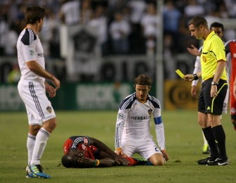 David Beckham #23 of Los Angeles Galaxy receives a yellow card as Tony Tchani #22 of Toronto FC writhes in pain from a hard tackle by Beckham in the first half during the MLS match at The Home Depot Center on June 11, 2011 in Carson, California. David Beckham #23 of Los Angeles Galaxy receives a yellow card as Tony Tchani #22 of Toronto FC writhes in pain from a hard tackle by Beckham in the first half during the MLS match at The Home Depot Center on June 11, 2011 in Carson, California.