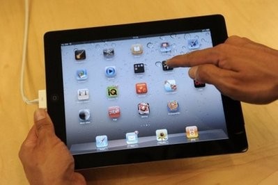 AFP file - A staff member poses with the iPad 2 at the Apple store in central London. AFP file - A staff member poses with the iPad 2 at the Apple store in central London.