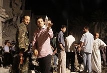 AFP – In a picture taken on a government guided tour, a man holds up a baby bottle as he stands with others AFP – In a picture taken on a government guided tour, a man holds up a baby bottle as he stands with others
