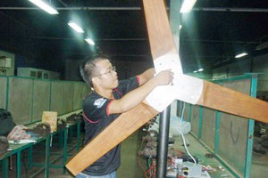 Caption: Tran Quoc Hieu with the wind-powered generator he made himself Caption: Tran Quoc Hieu with the wind-powered generator he made himself