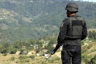 File photo of an State Police officer in Oaxaca, Mexico. Gunmen have kidnapped at least 60 undocumented migrants, including children, who were aboard a freight train in Mexico trying to get to the United States, a shelter director said File photo of an State Police officer in Oaxaca, Mexico. Gunmen have kidnapped at least 60 undocumented migrants, including children, who were aboard a freight train in Mexico trying to get to the United States, a shelter director said