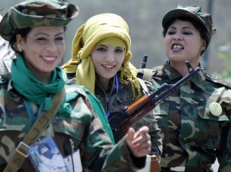 Libyan women and supporters of Libyan leader Moamer Kadhafi wear army fatigues and hold up weapons as they attend a women's forum in Tripoli on June 25, 2011. AFP Libyan women and supporters of Libyan leader Moamer Kadhafi wear army fatigues and hold up weapons as they attend a women's forum in Tripoli on June 25, 2011. AFP