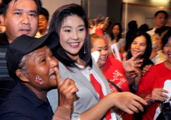 AFP - Yingluck Shinawatra (C) greets supporters during her election campaign in Bangkok on June 27, 2011. AFP - Yingluck Shinawatra (C) greets supporters during her election campaign in Bangkok on June 27, 2011.