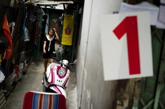 AFP - A woman walk outside her house next to a number 1 campaign billboard for Yingluck Shinawatra Pheu Thai party candidate, youngest sister of ex-prime minister Thaksin Shinawatra, for the upcoming elections in Bangkok on June 30, 2011. AFP - A woman walk outside her house next to a number 1 campaign billboard for Yingluck Shinawatra Pheu Thai party candidate, youngest sister of ex-prime minister Thaksin Shinawatra, for the upcoming elections in Bangkok on June 30, 2011.