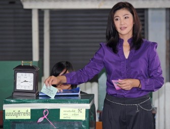 AFP - Yingluck Shinawatra, opposition Puea Thai party candidate and sister of fugitive Thai ex-prime minister Thaksin Shinawatra, places a ballot in ballot box during voting at polling station in Bangkok on July 3, 2011. AFP - Yingluck Shinawatra, opposition Puea Thai party candidate and sister of fugitive Thai ex-prime minister Thaksin Shinawatra, places a ballot in ballot box during voting at polling station in Bangkok on July 3, 2011.