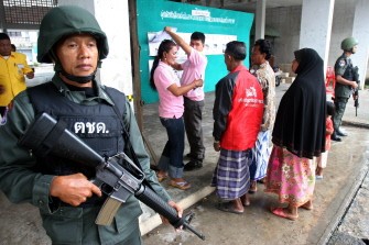 AFP - Thai soldiers stand guard outside a polling station during the country's general election in Thailand's restive southern province of Yala on July 3, 2011. AFP - Thai soldiers stand guard outside a polling station during the country's general election in Thailand's restive southern province of Yala on July 3, 2011.