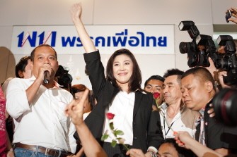 AFP - Yingluck Shinawatra, opposition Puea Thai party candidate and sister of Thaksin Shinawatra, celebrates her victory at the party headquarter in Bangkok on July 3, 2011. AFP - Yingluck Shinawatra, opposition Puea Thai party candidate and sister of Thaksin Shinawatra, celebrates her victory at the party headquarter in Bangkok on July 3, 2011.