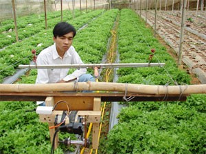 Pham Minh Quy poses with his automatic plant chemical spraying machine Pham Minh Quy poses with his automatic plant chemical spraying machine