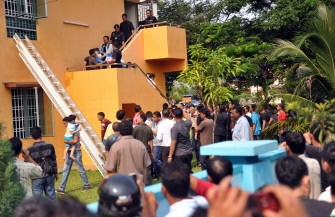 AFP - Malaysian security officials rescue pre-school children after a successful operation against a hostage taker in Muar AFP - Malaysian security officials rescue pre-school children after a successful operation against a hostage taker in Muar