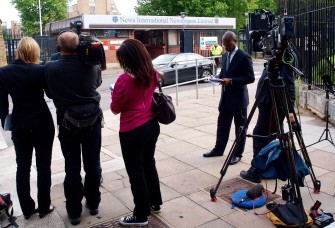 Journalists wait as a car leaves News International's office in London, on July 7, 2011, as Rupert Murdoch decided to close News of the World after it was engulfed in a phone hacking scandal. Journalists wait as a car leaves News International's office in London, on July 7, 2011, as Rupert Murdoch decided to close News of the World after it was engulfed in a phone hacking scandal.