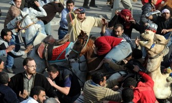 (AFP FILES) A picture taken on February 2, 2011 shows supporters of then Egyptian president Hosni Mubarak, on horses and a camel, clashing with anti-regime protesters in Cairo. (AFP FILES) A picture taken on February 2, 2011 shows supporters of then Egyptian president Hosni Mubarak, on horses and a camel, clashing with anti-regime protesters in Cairo.