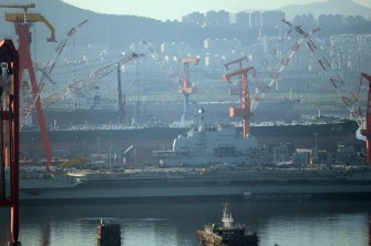 AFP - The 300 metre (990-foot) former Soviet carrier, originally called the Varyag, sits in the port as she is overhauled in the northeast port of Dalian, northwest China's Liaoning province on July 4, 2011. AFP - The 300 metre (990-foot) former Soviet carrier, originally called the Varyag, sits in the port as she is overhauled in the northeast port of Dalian, northwest China's Liaoning province on July 4, 2011.