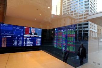 AFP - A streetscape is reflected in the window of the newly refurbished Australian Stock Exchange in Sydney on July 11, 2011 after the announcement of the new tax on carbon emissions. AFP - A streetscape is reflected in the window of the newly refurbished Australian Stock Exchange in Sydney on July 11, 2011 after the announcement of the new tax on carbon emissions.
