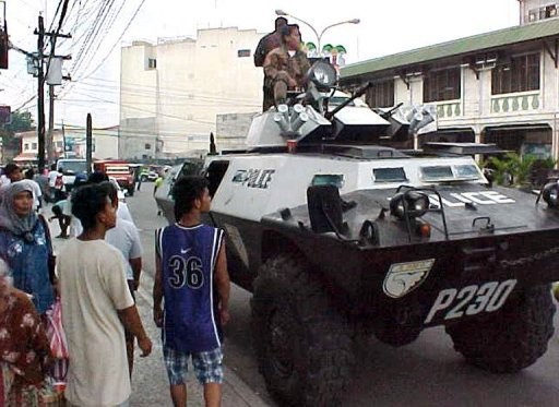 Soldiers and armed police in armoured personnel carriers guard the busy district of Zamboanga in the southern Philippines. Gunmen abducted two US citizens and their Filipino relative holidaying at a tiny southern Philippine island close to the city, police have said Soldiers and armed police in armoured personnel carriers guard the busy district of Zamboanga in the southern Philippines. Gunmen abducted two US citizens and their Filipino relative holidaying at a tiny southern Philippine island close to the city, police have said