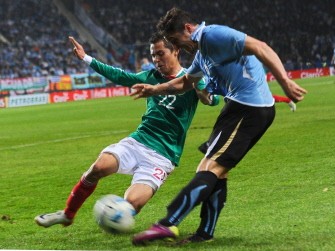 AFP - Uruguay's Cristian Rodriguez kicks while Mexican Paul Aguilar tries to block the shot during their match on July 12, 2011 AFP - Uruguay's Cristian Rodriguez kicks while Mexican Paul Aguilar tries to block the shot during their match on July 12, 2011