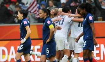 AFP - USA's teammates (R) celebrate as France's look on after their game AFP - USA's teammates (R) celebrate as France's look on after their game