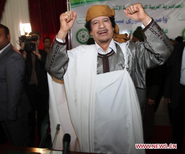 Libyan leader Muammar Gaddafi gestures to his supporters during a ceremony marking the 34th anniversary of the launch of the Popular Committees in Tripoli, capital of Libya, March 2, 2011. Libyan leader Muammar Gaddafi gestures to his supporters during a ceremony marking the 34th anniversary of the launch of the Popular Committees in Tripoli, capital of Libya, March 2, 2011.