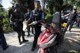 Thai police officers inspect the site where a Muslim religious leader and his wife were shot dead by suspected separatist militants as they were riding a motorcycle in Thailand's restive southern province of Narathiwat on July 11, 2011. Thai police officers inspect the site where a Muslim religious leader and his wife were shot dead by suspected separatist militants as they were riding a motorcycle in Thailand's restive southern province of Narathiwat on July 11, 2011.