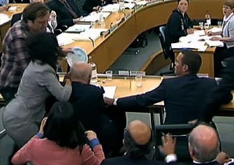 AFP - A screen grab image taken in London on July 19, 2011, shows a man (Top L) hitting Rupert Murdoch (2nd Row Seated L) in the face with a plate of foam as he and son James (2nd Row Seated R) give evidence to a Parliamentary Select Committee on the phone hacking scandal AFP - A screen grab image taken in London on July 19, 2011, shows a man (Top L) hitting Rupert Murdoch (2nd Row Seated L) in the face with a plate of foam as he and son James (2nd Row Seated R) give evidence to a Parliamentary Select Committee on the phone hacking scandal