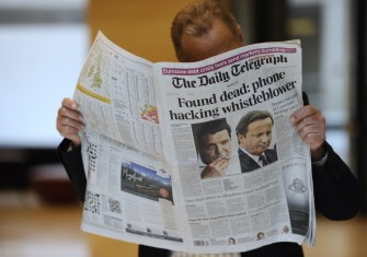 AFP - A person reads on July 19, 2011, in Paris, the British daily newspaper, The Daily Telegraph of which front page is on the spiralling phone-hacking scandal. AFP - A person reads on July 19, 2011, in Paris, the British daily newspaper, The Daily Telegraph of which front page is on the spiralling phone-hacking scandal.