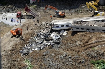 AFP - This aerial photo taken on July 24, 2011 shows workers clearing the wreckages after the two high-speed trains collided AFP - This aerial photo taken on July 24, 2011 shows workers clearing the wreckages after the two high-speed trains collided